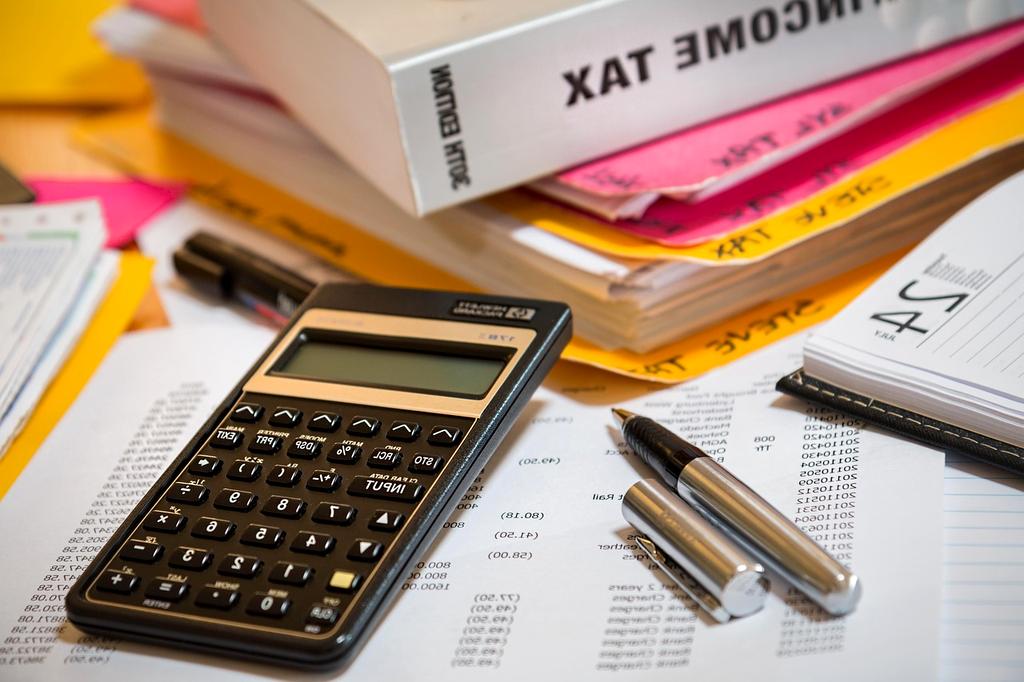 Young professional planning finances with multiple charts and a calculator
