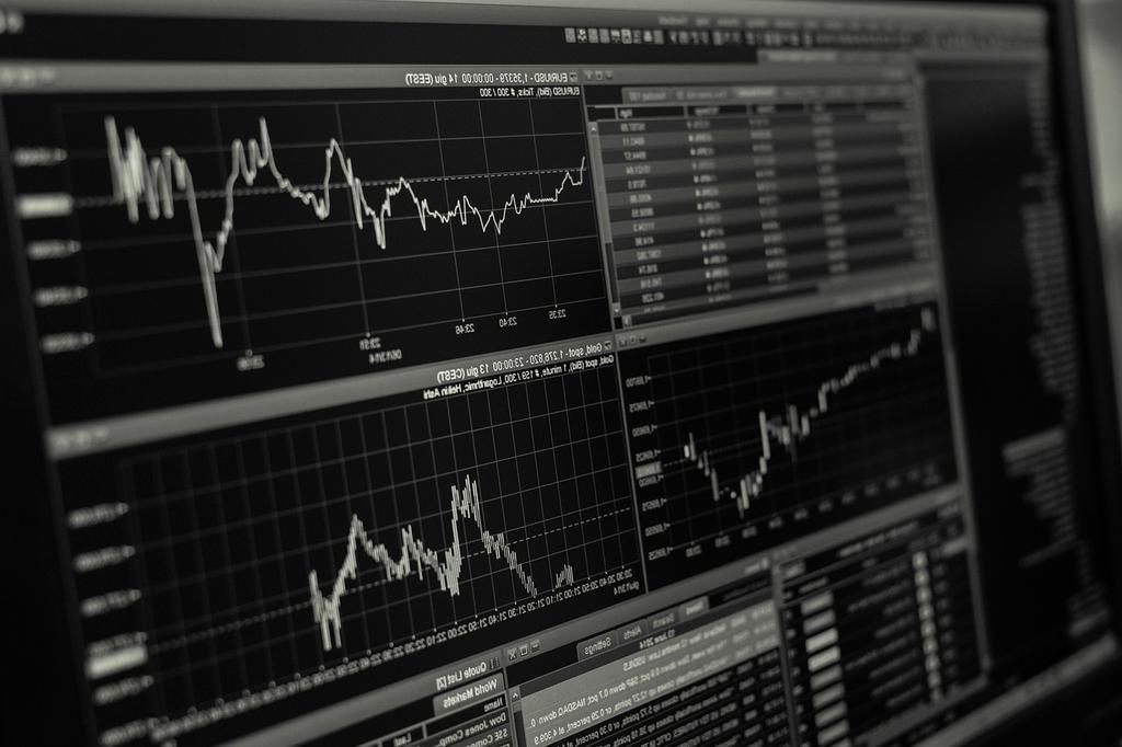 Young entrepreneur reviewing investment portfolio charts at home office