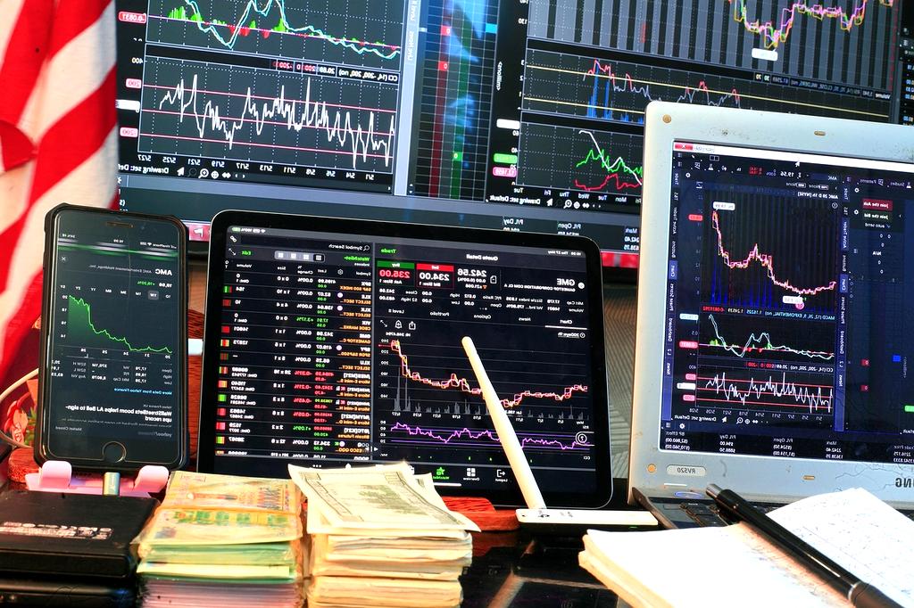 Marketing professional reviewing investment portfolio on tablet in modern workspace